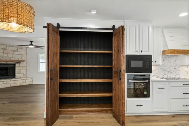 Elegant custom pantry with ample shelving for organized storage. | Image 13