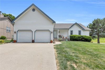 Ranch-style house featuring a garage and a front yard | Image 3