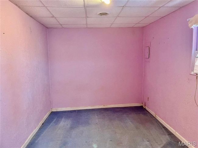 Spare room with a drop ceiling and concrete flooring | Image 8