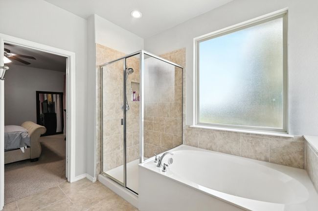 Ensuite bathroom with a garden tub, a stall shower, tile patterned floors, a ceiling fan, and recessed lighting | Image 12