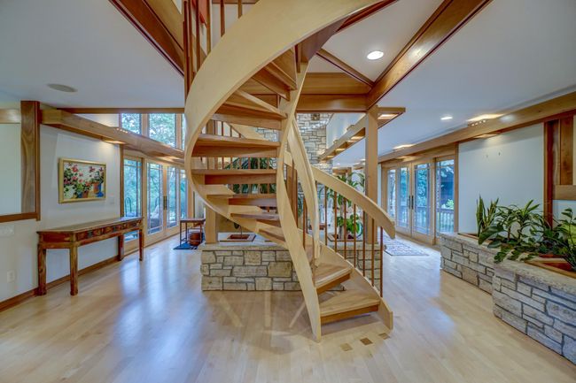 Each floor has two sets of stair cases including this custom York spiral stair case | Image 24