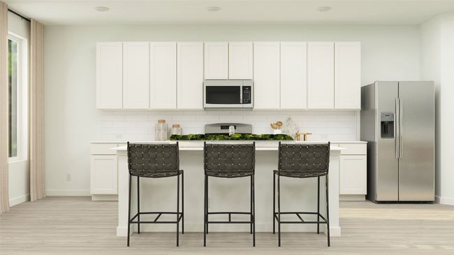 Kitchen featuring stainless steel fridge with ice dispenser, a breakfast bar, light wood-style floors, and a center island with sink | Image 4