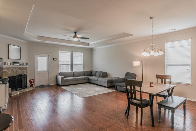 Open Living room with wood-type flooring, ceiling fan with fireplace, and ornamental molding | Image 20