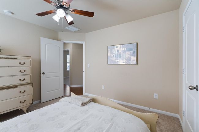 Bedroom 2 - The split layout places the secondary bedrooms near the front of the home. | Image 19