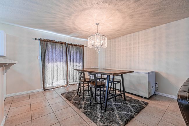 Tiled dining area featuring a chandelier | Image 10