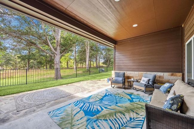Large covered porch with view of the fully fenced backyard | Image 19