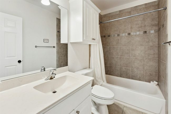 Bathroom featuring vanity, shower / bathtub combination with curtain, and tile patterned flooring | Image 20