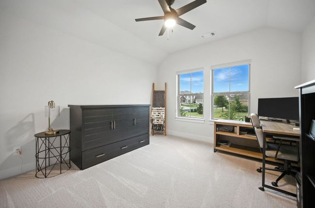 Upstairs Bedroom with vaulted ceiling, a desk, carpet flooring, and ceiling fan | Image 35