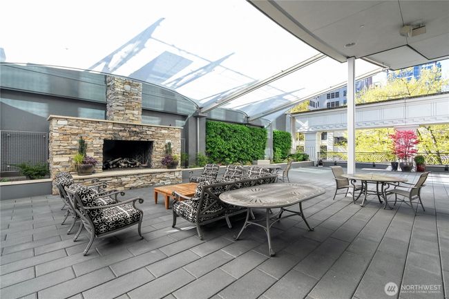 Cozy outdoor terrace featuring comfortable seating and dual gas grills, ideal for entertaining and relaxation. | Image 24