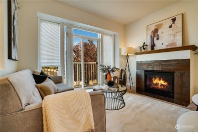 The main floor boasts a cozy fireplace, perfect for unwinding on chilly evenings, and a lovely balcony that showcases stunning city views—your ideal retreat for relaxation and inspiration! | Image 2