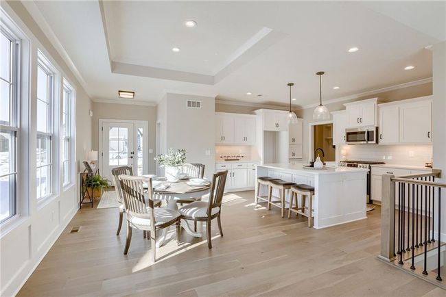 Dining room with ornamental molding, visible vents, and light wood-type flooring | Image 9