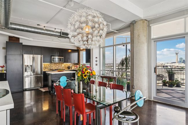 Dining table with chandelier paying homage to Reunion Tower. | Image 9