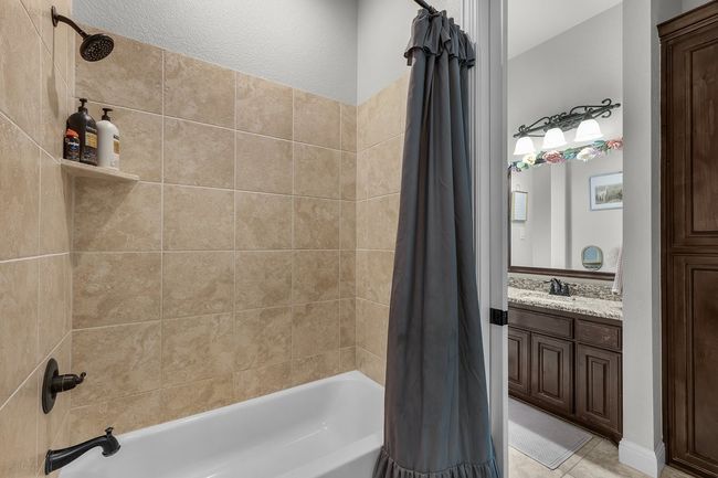 Full bath featuring shower / bathtub combination with curtain and vanity | Image 29
