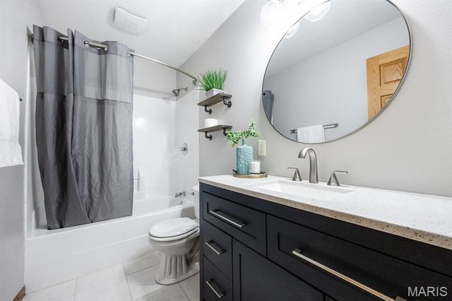Bathroom featuring shower / bath combo, vanity, tile patterned floors, and toilet | Image 28