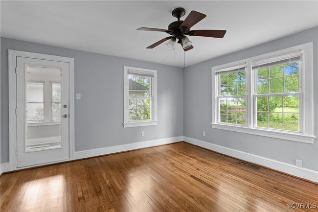 Unfurnished room featuring visible vents, ceiling fan, baseboards, and wood-type flooring | Image 19