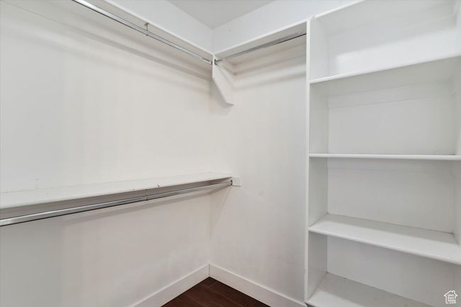 Walk in closet with dark wood finished floors | Image 17