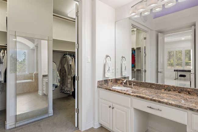 Full bath featuring healthy amount of natural light, a spacious closet, vanity, and tile patterned floors | Image 21