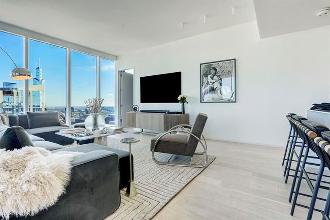 Living area featuring a wall of windows and wood finished floors | Image 5