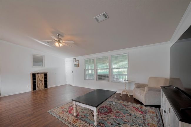 With beautiful molding and a modern ceiling fan adding a touch of sophistication. | Image 11