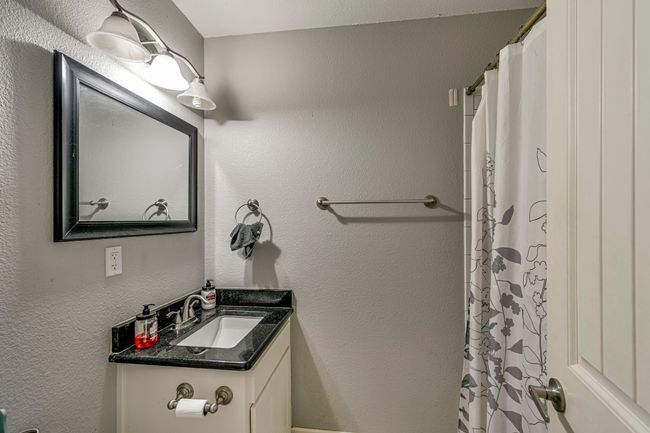 Bathroom featuring vanity and a textured wall | Image 8
