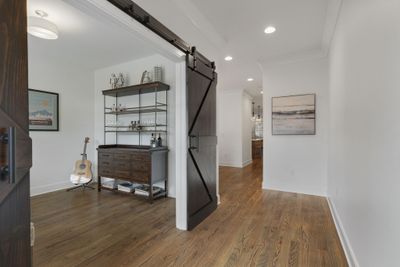 Welcome! First up....flex space to fit your specific needs! Music room, tasting room, office, exercise area, bonus room. Barn doors create a nice architectural accent and rich contrast against the freshly painted walls. | Image 2