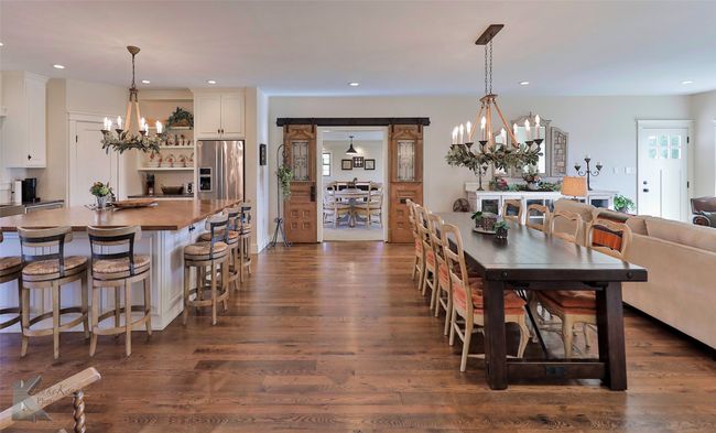 Dining area with a chandelier, dark wood-style floors, and recessed lighting | Image 8