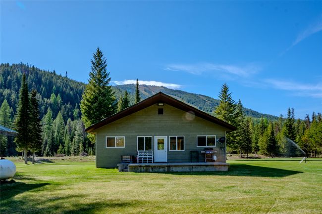 Back of property featuring a forest view, a mountain view, and a lawn | Image 78