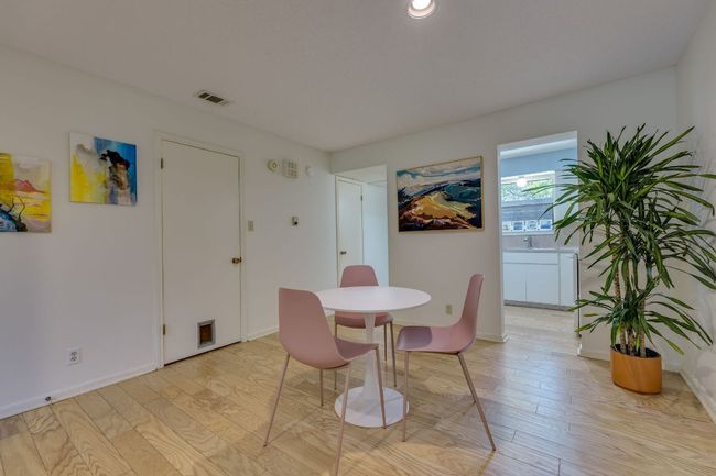 Dining area with light wood-style flooring and baseboards | Image 13