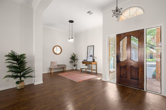 Foyer entrance with crown molding and dark wood-type flooring | Image 6