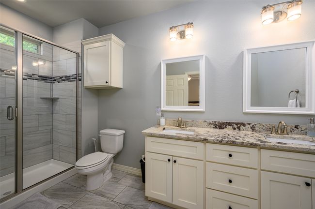 Master Bath features enclosed shower, tile flooring, double vanity. | Image 10