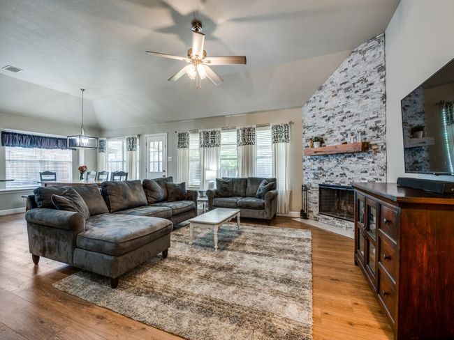 Living room with brick fireplace | Image 4