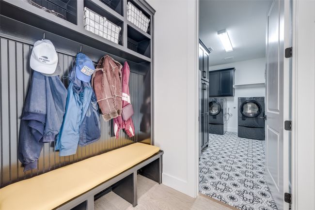 Mudroom with washer and dryer has 2nd door into primary closet | Image 14