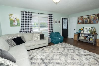 Living room with dark wood-type flooring | Image 2