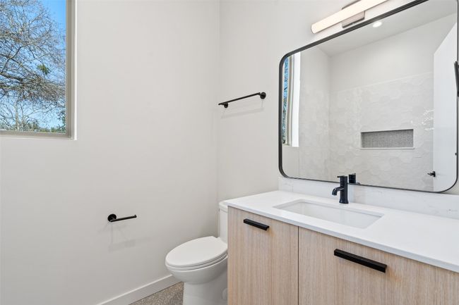 Half bath featuring baseboards, vanity, and toilet | Image 12