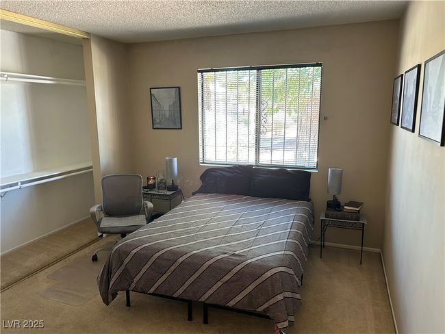 Carpeted bedroom featuring a textured ceiling | Image 30