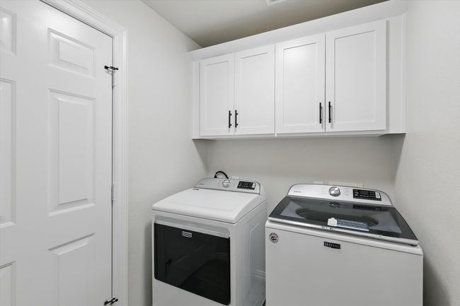 Laundry room featuring cabinet space and washing machine and clothes dryer | Image 30