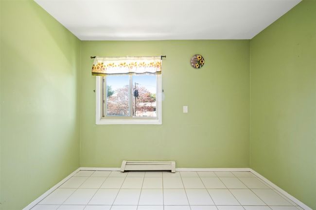 Spare room with baseboards and a baseboard heating unit | Image 7