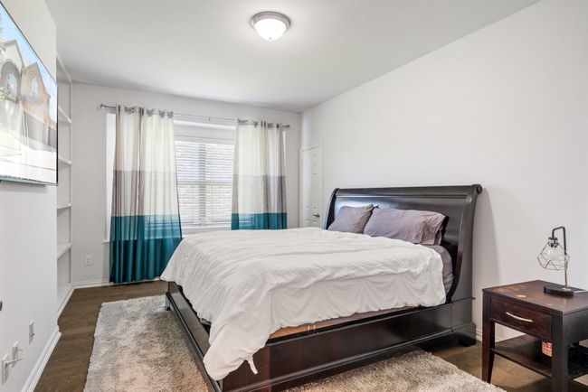 Bedroom featuring baseboards and wood finished floors | Image 27