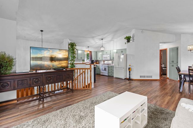 The upper level has a great flow with its open concept and newer LVP flooring (2020) throughout the main area! The matching matte black light fixtures were also updated in 2020. | Image 4
