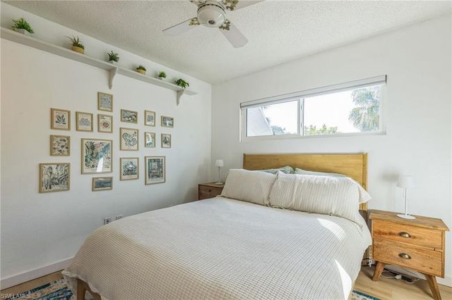 Bedroom with a textured ceiling, a ceiling fan, and wood finished floors | Image 26