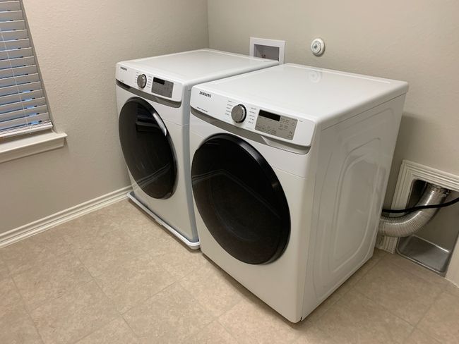 Clothes washing area featuring baseboards, washing machine and dryer, and laundry area | Image 27