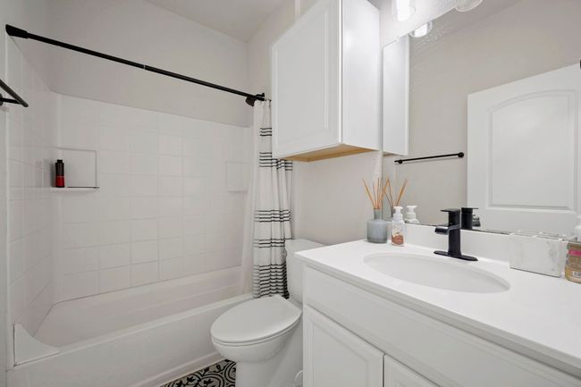 Bathroom with toilet, vanity, and shower / bath combo | Image 11