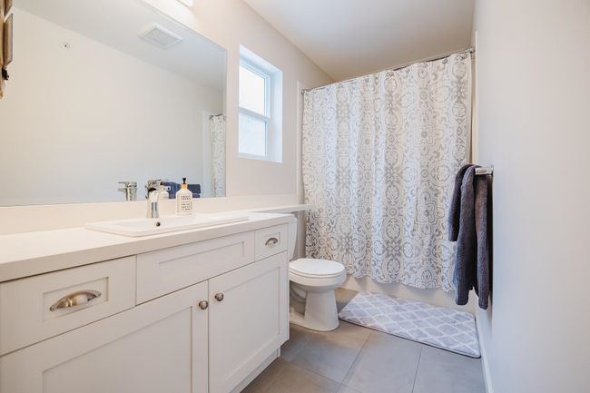 Bathroom with vanity, toilet, tile patterned flooring, and visible vents | Image 23