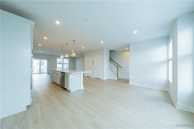 Kitchen featuring dishwasher, a sink, light countertops, a center island with sink, and recessed lighting | Image 20