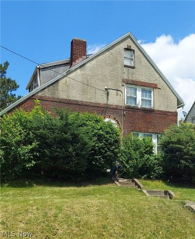 View of property exterior with a lawn | Image 1