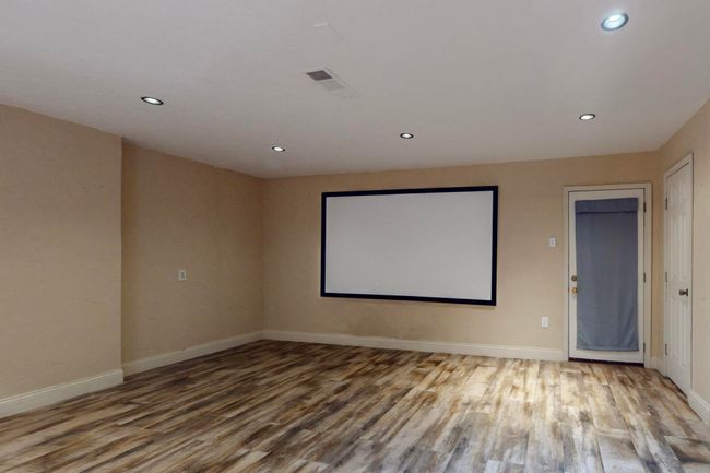 Home theater featuring recessed lighting, visible vents, baseboards, and wood finished floors | Image 18