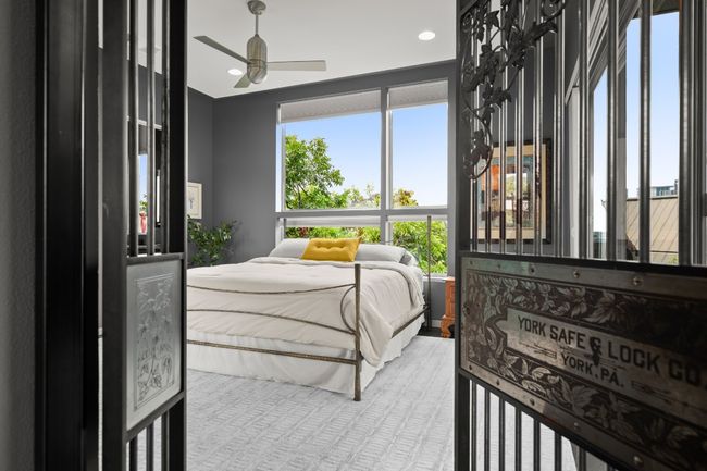 Back to the primary bedroom, featuring the $20, 000 historic bank door and skyline views. | Image 17