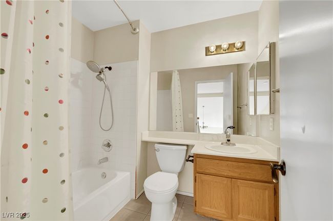 Full bath featuring toilet, vanity, shower / tub combination, and tile patterned floors | Image 36