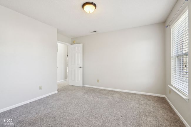 carpeted empty room featuring baseboards | Image 59