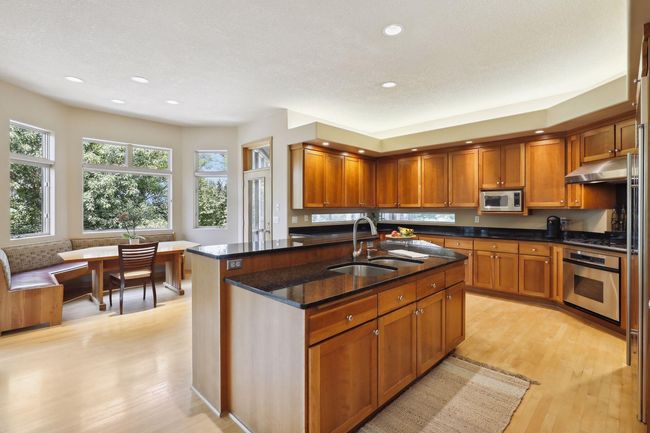 Stunning, modern design! Large center island with sink and breakfast bar. Tons of cabinetry! | Image 8